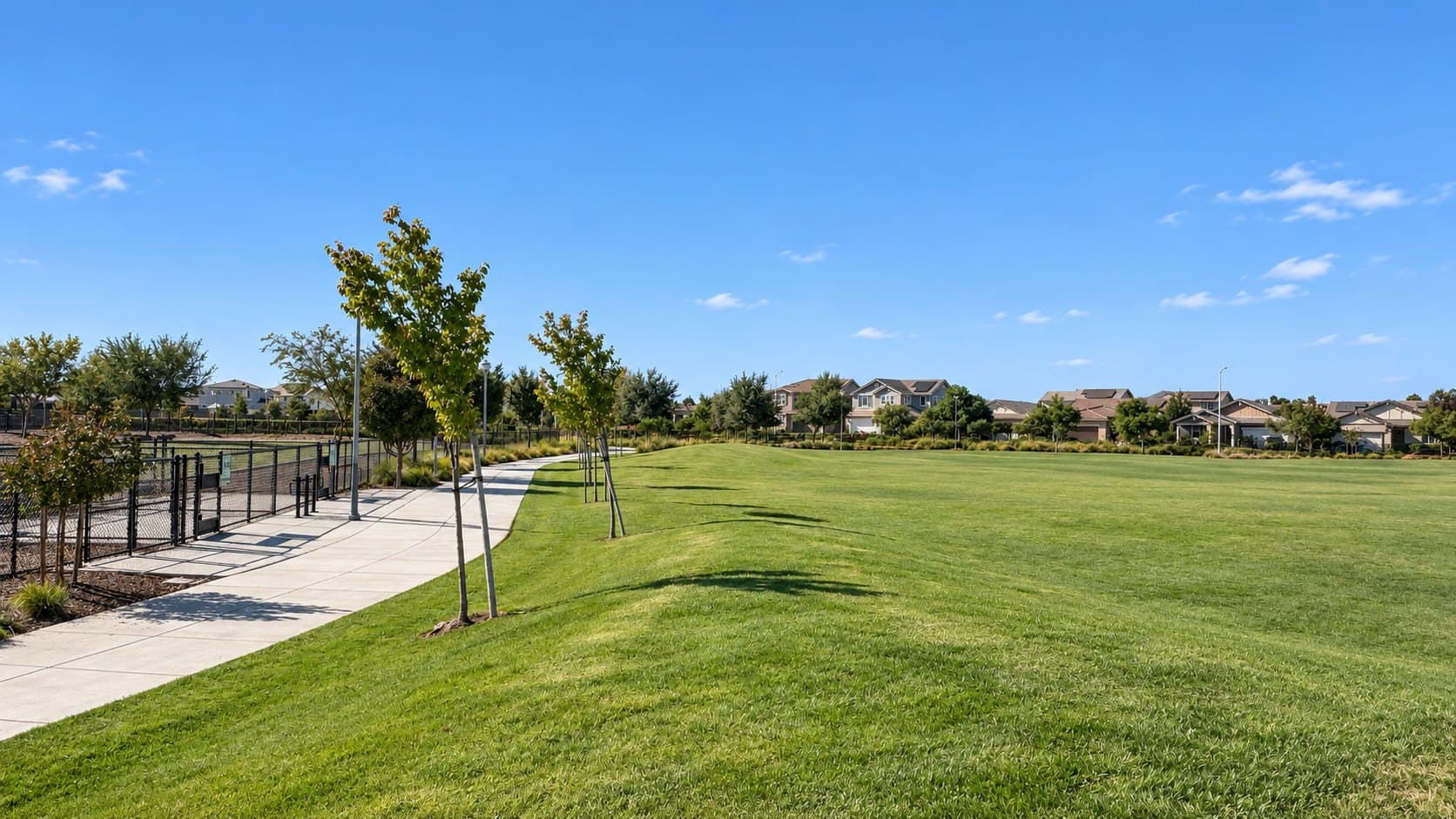 Wide green lawn at the community park beside the home