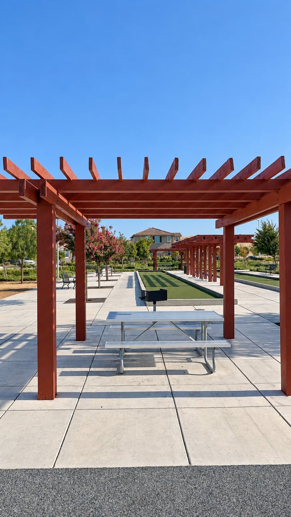Picnic table under a wooden pergola at the neighborhood park